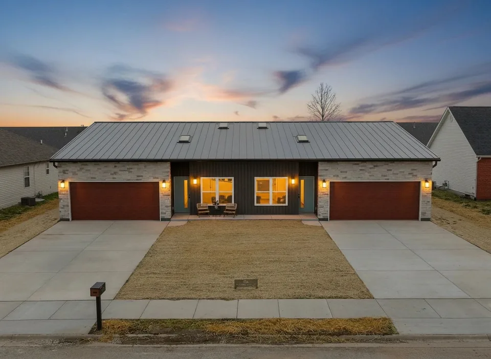 The Duo at dusk: two garages with a shared covered entry